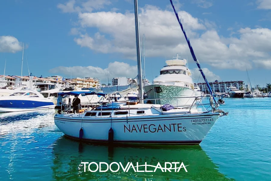 Puerto Vallarta Sailing 30 - Navegante S docked at the marina with luxury yachts in the background.
