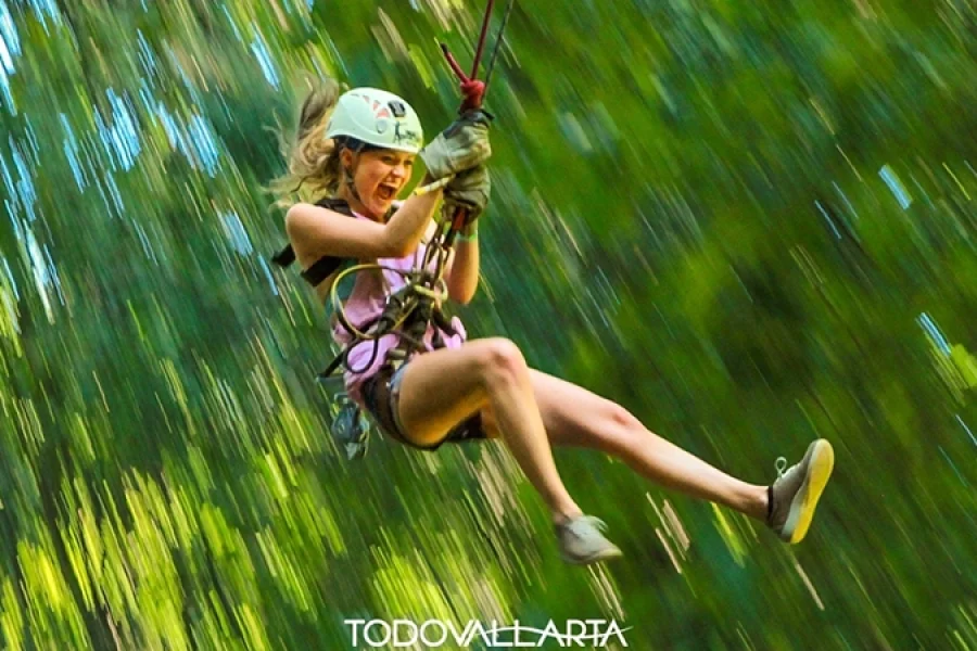 Woman ziplining fast through the jungle canopy in Puerto Vallarta adventure tour.