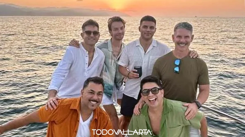 A group of men posing for a sunset photo on the deck of the LGBT Sunset Cruise yacht.