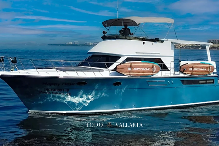 Side view of Happy Hour yacht, showing full profile on the water