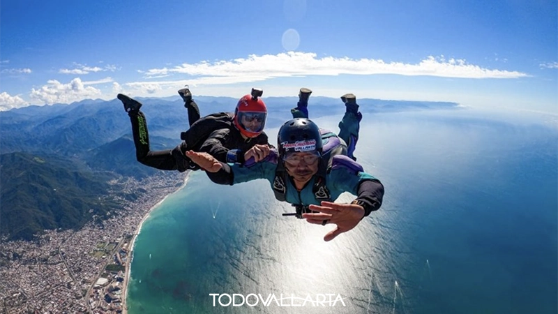 Skydivers midair above the ocean