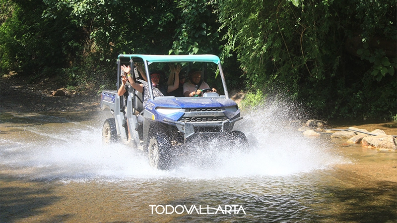 RZR driving across a clear jungle river in Puerto Vallarta