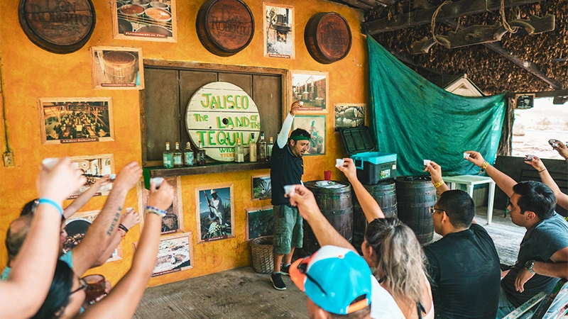 Tourists sampling tequila at a traditional tasting stop in Puerto Vallarta