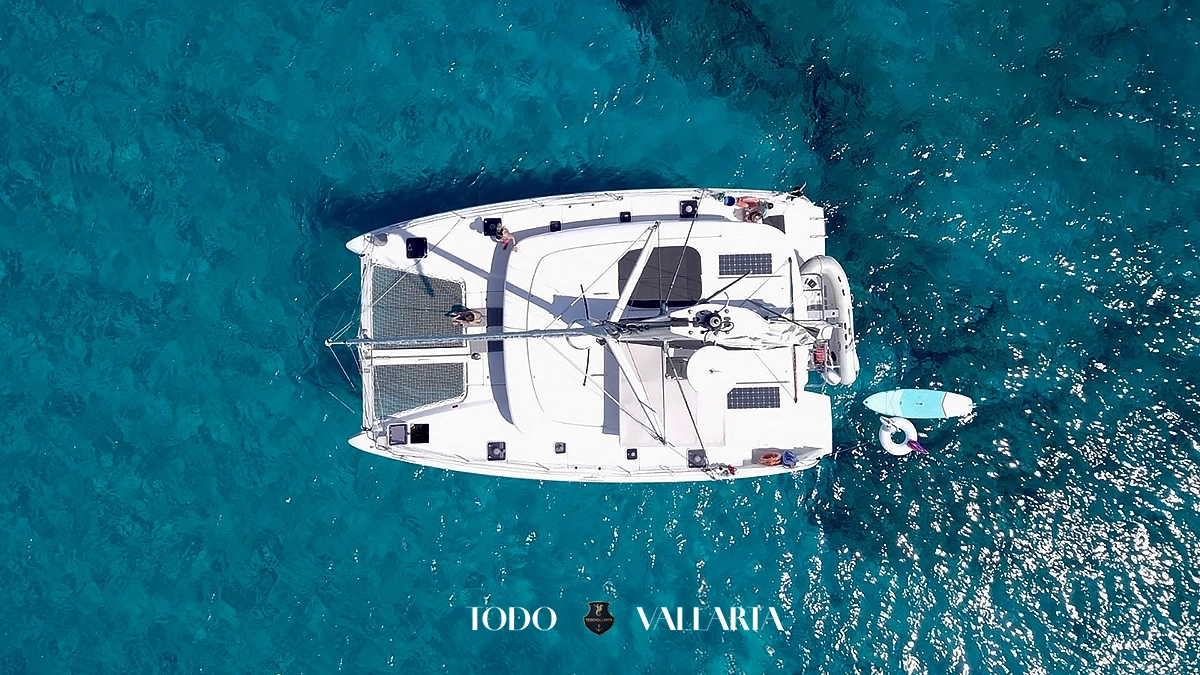 charter goa - 42Ft luxury catamaran top-down drone shot over netted trampoline and paddleboard in Banderas Bay