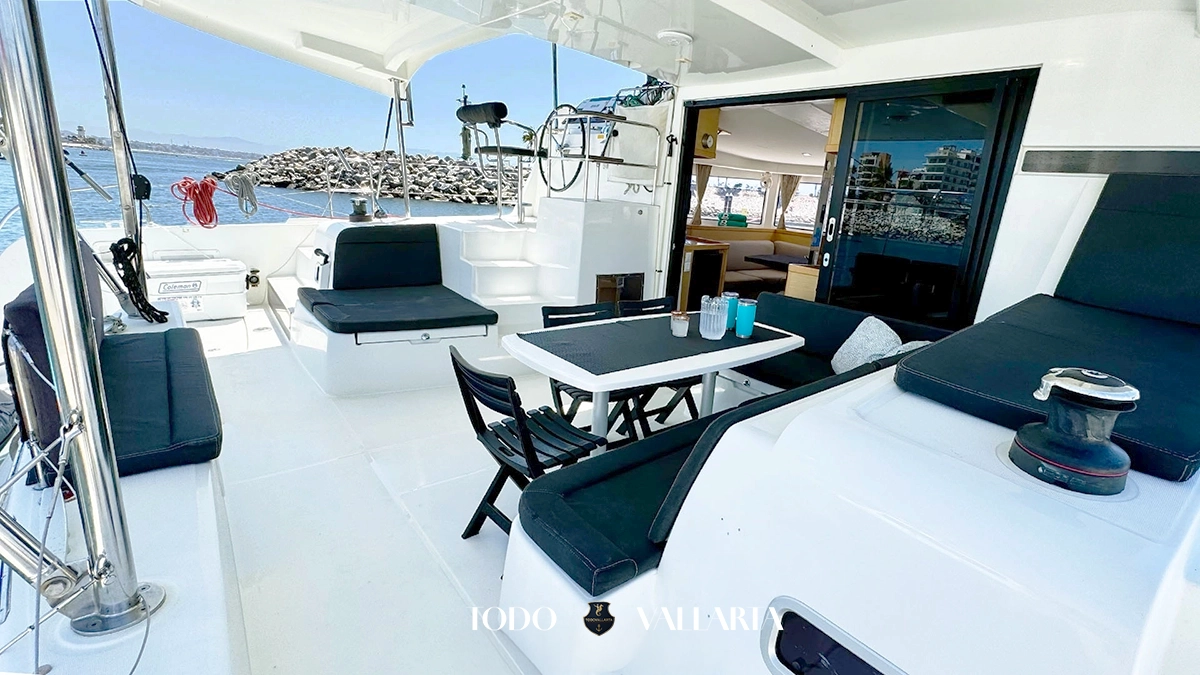 charter goa - 42Ft luxury catamaran aft cockpit lounge with dining area and open salon entry